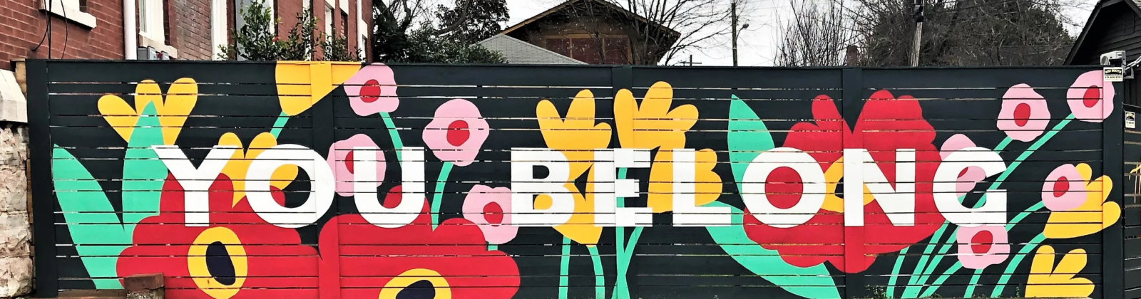 colorful mural on fence with words YOU BELONG